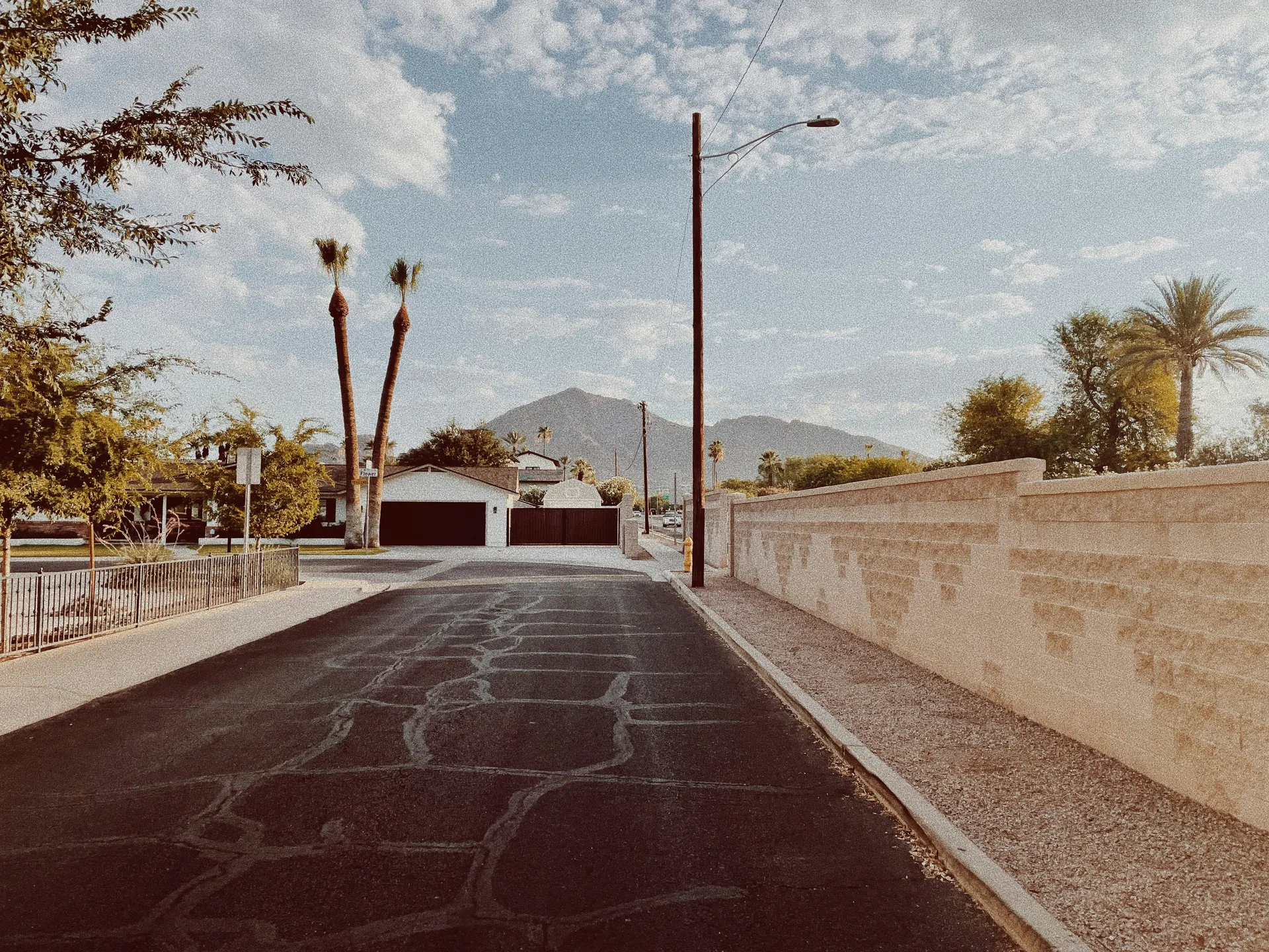 A light gray concrete driveway with a modern, stamped pattern