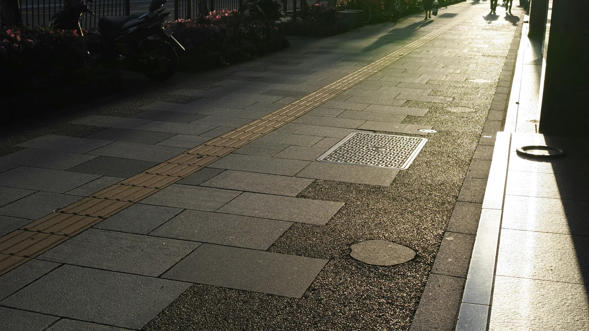 A gorgeous driveway made of interlocking gray pavers in an intricate pattern