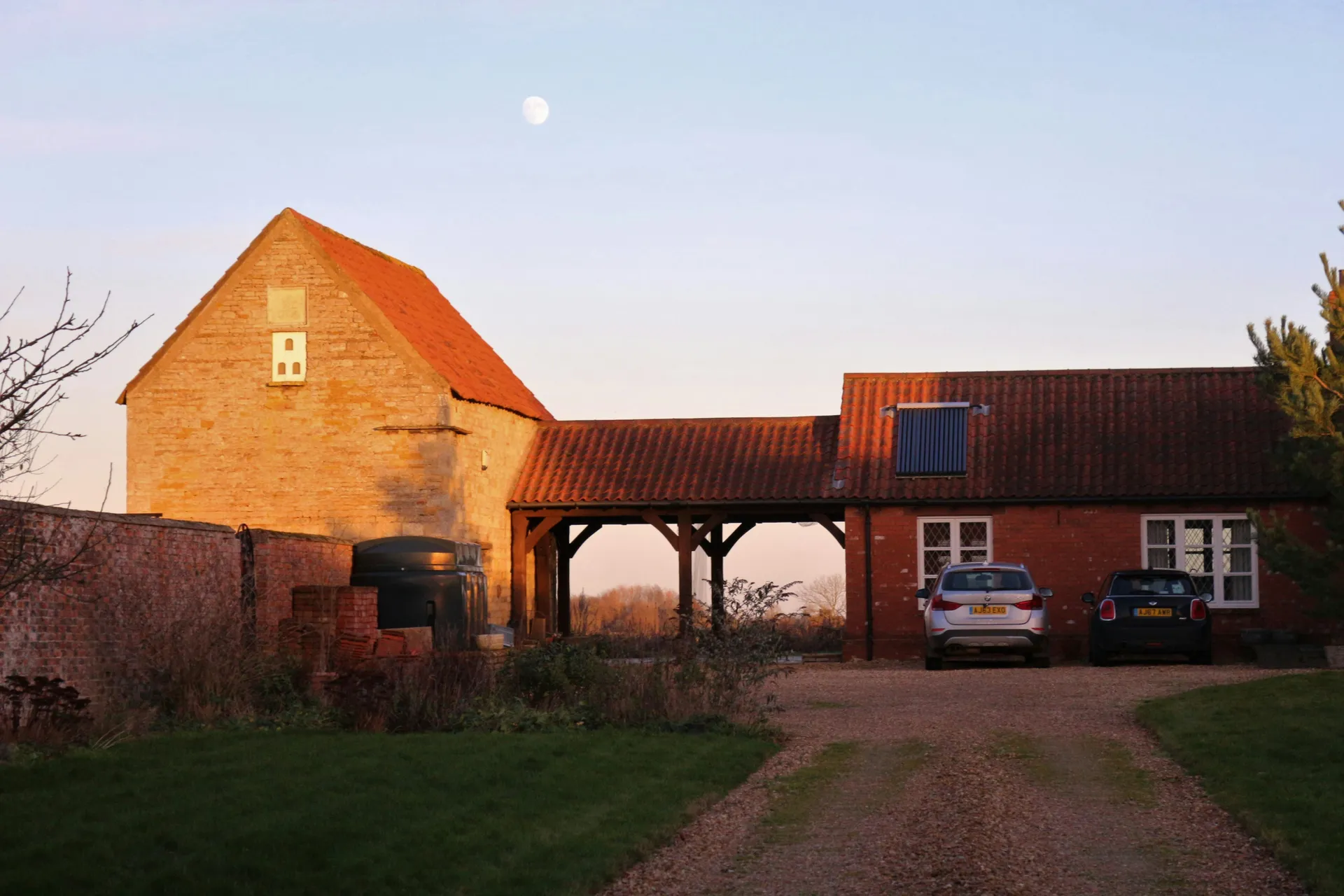 A photo gallery showing a modern Dutch Colonial home, a classic red barn, and a stylish shed, all featuring gambrel roofs.