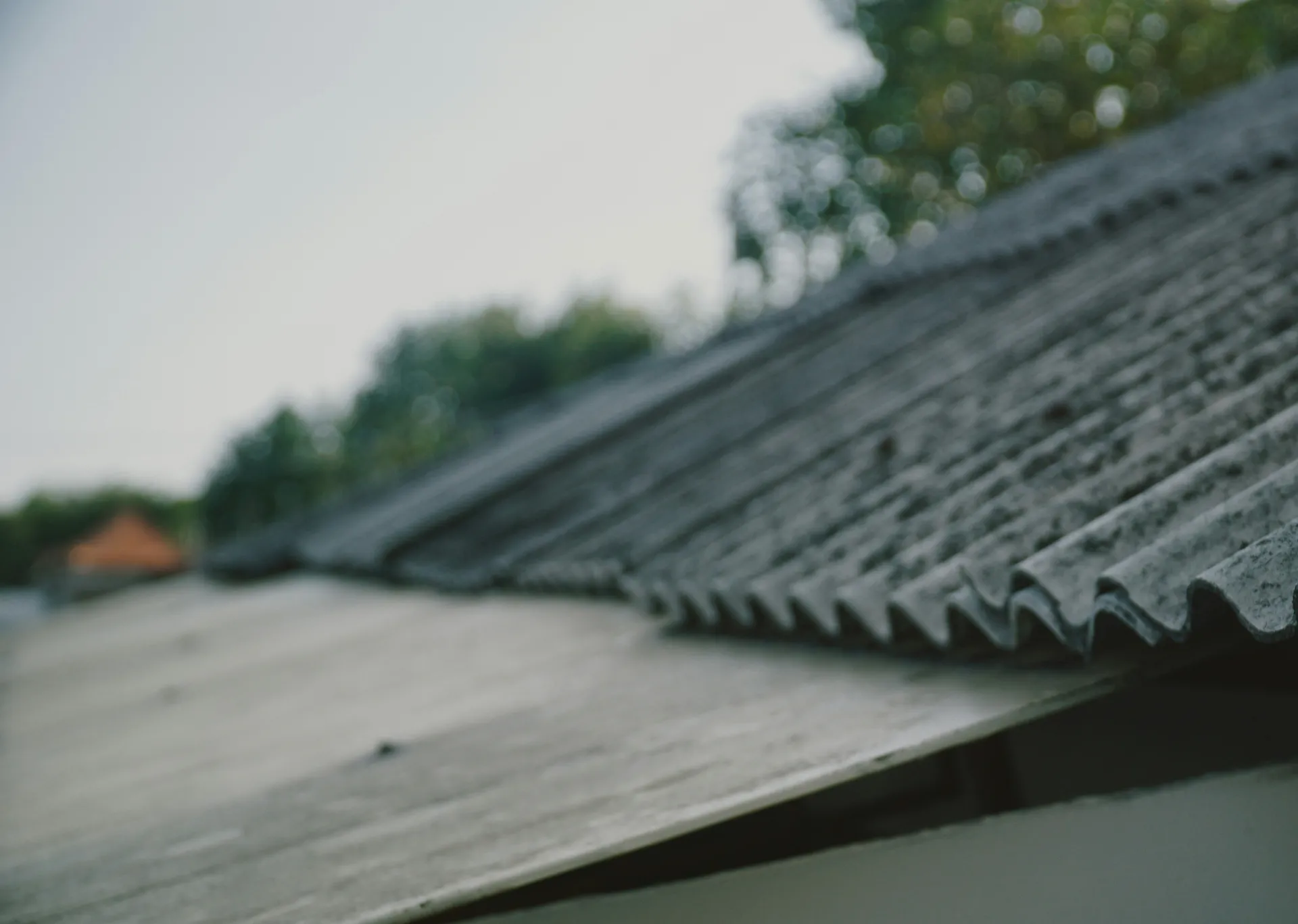 A close-up view of a clean, professionally installed roof edge showing the metal flashing and gutter system.