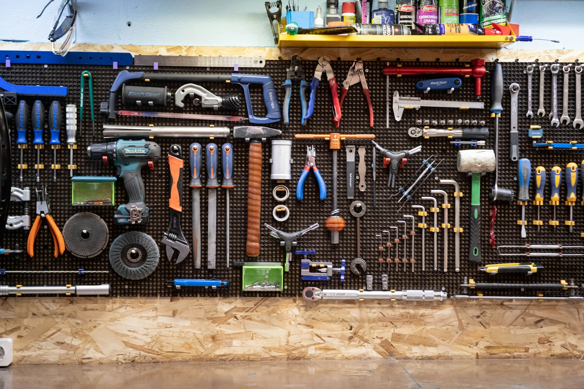 A collection of repair tools like a wrench and flashlight on a blueprint, symbolizing emergency home repairs.