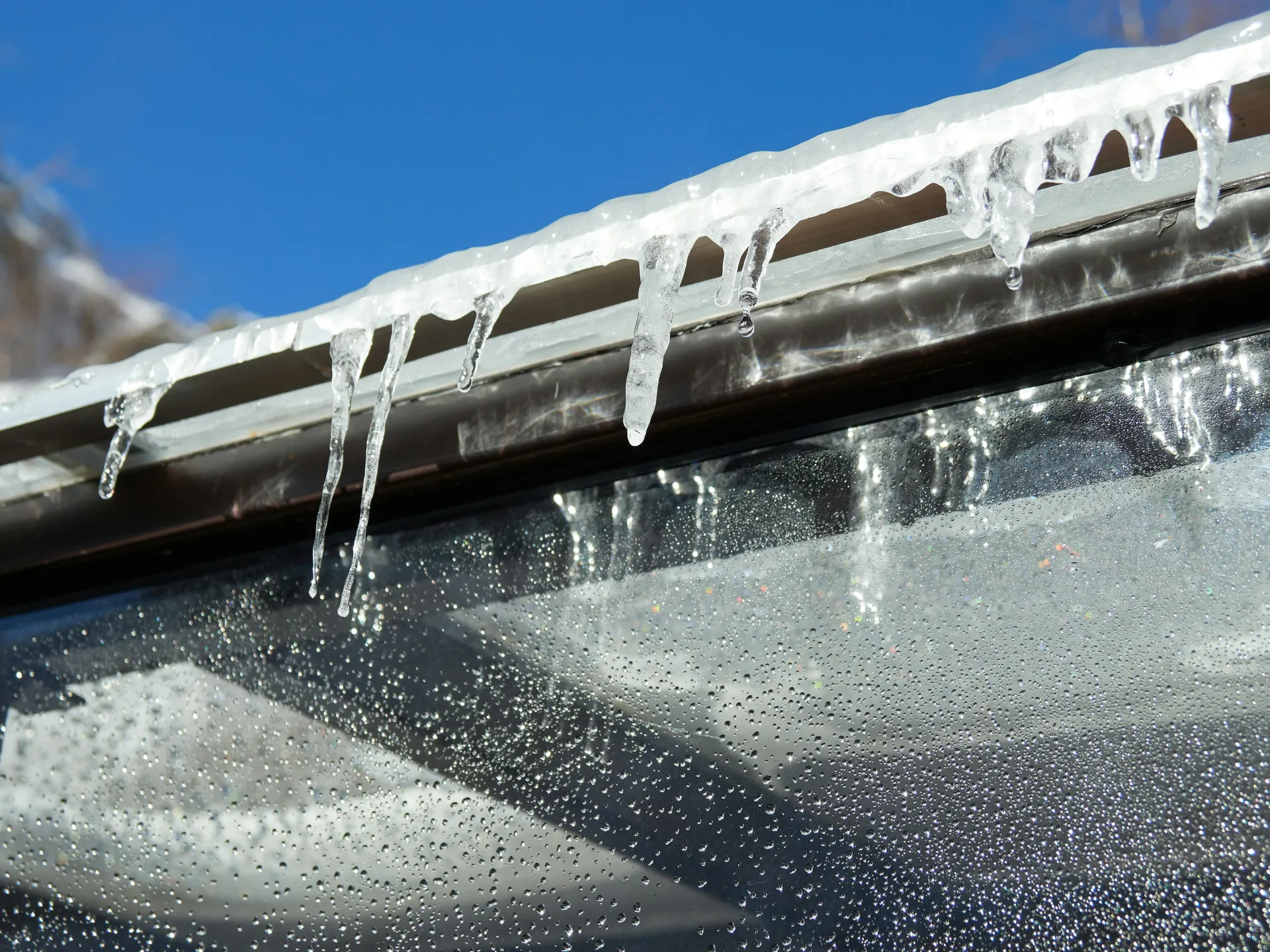 A close-up of a cracked rubber boot around a vent pipe on a roof, a common source of leaks.