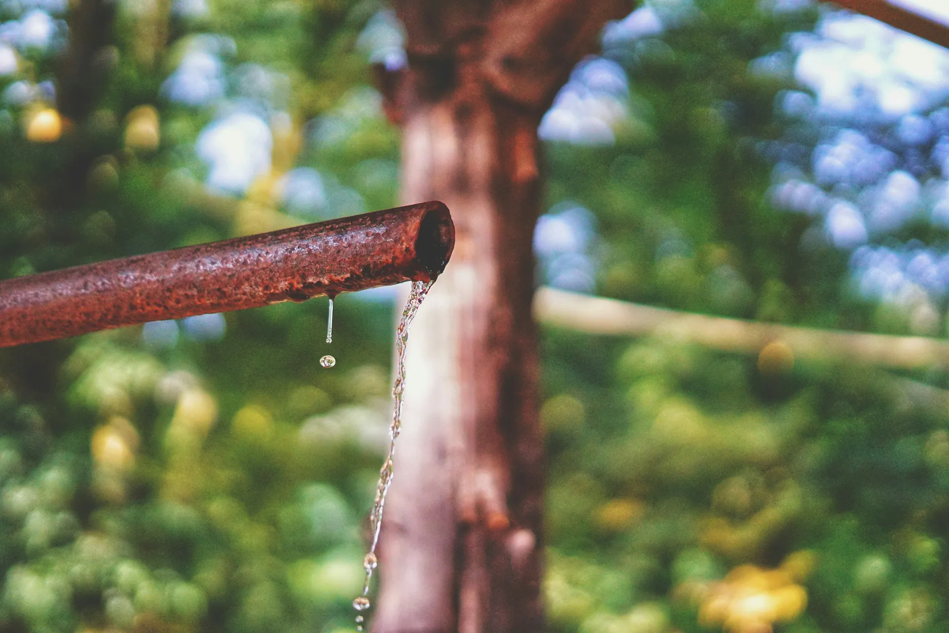 A cross-section of a heavily corroded and clogged galvanized water pipe.