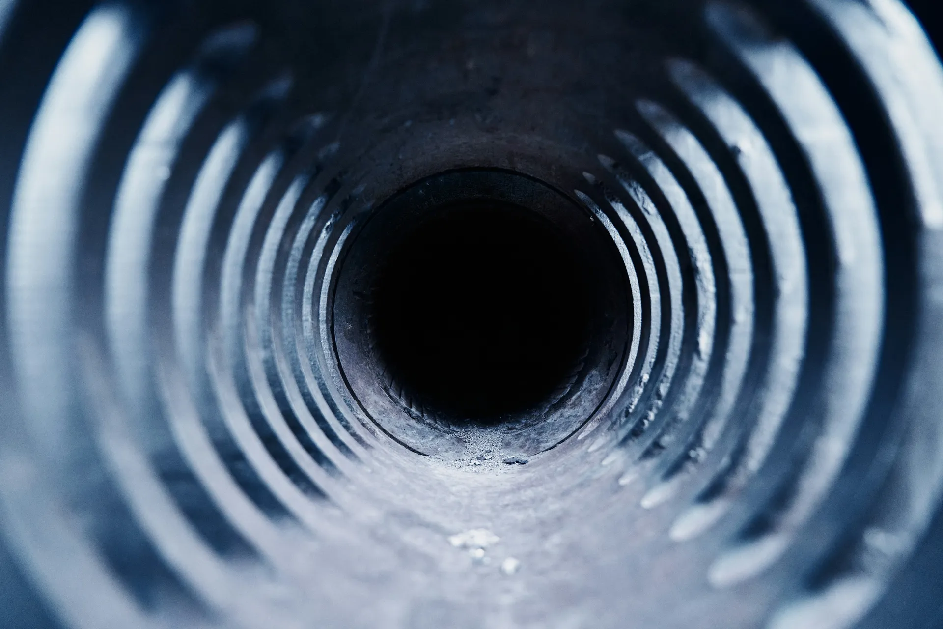 Cross-section diagram showing a resin-saturated liner being installed and inflated inside a damaged pipe, creating a new seamless pipe within the old one.